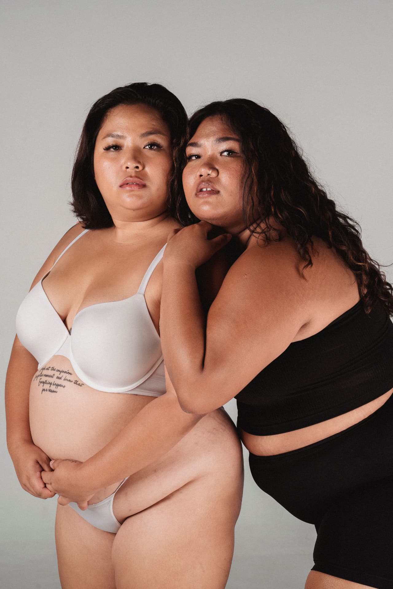 Two women standing together, supporting each other