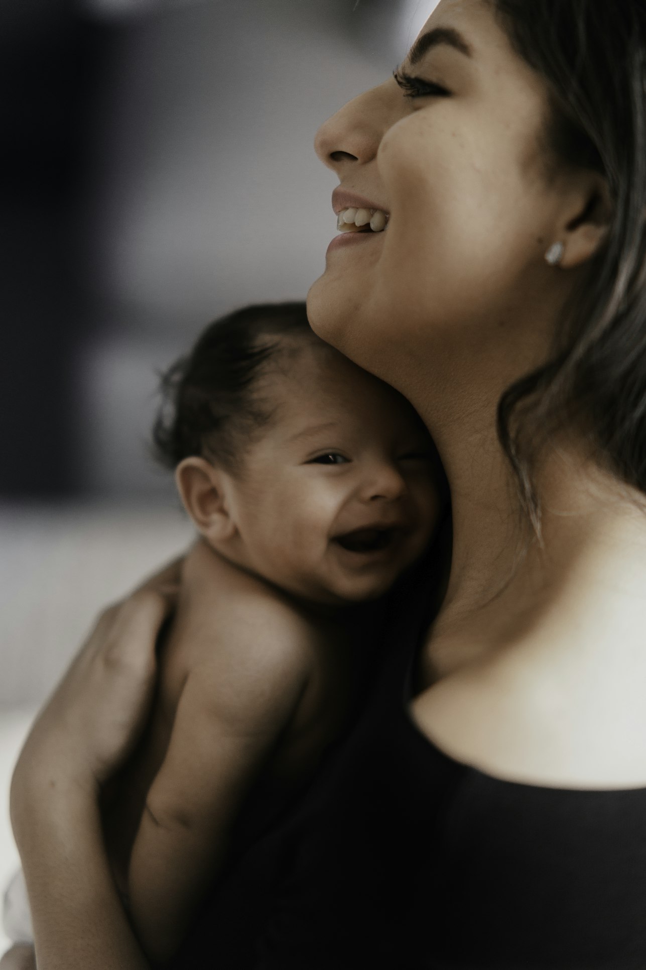 A parent holding their newborn close